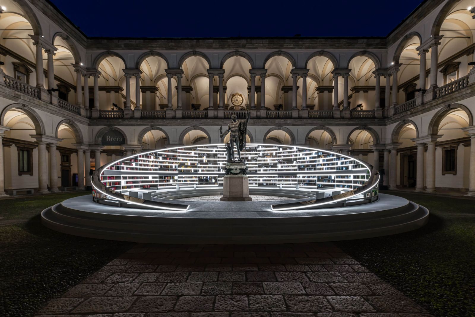 The rotating library is a monumental bookcase containing real books, their spines arranged in a chromatic spectrum—forming a rainbow when viewed during daytime