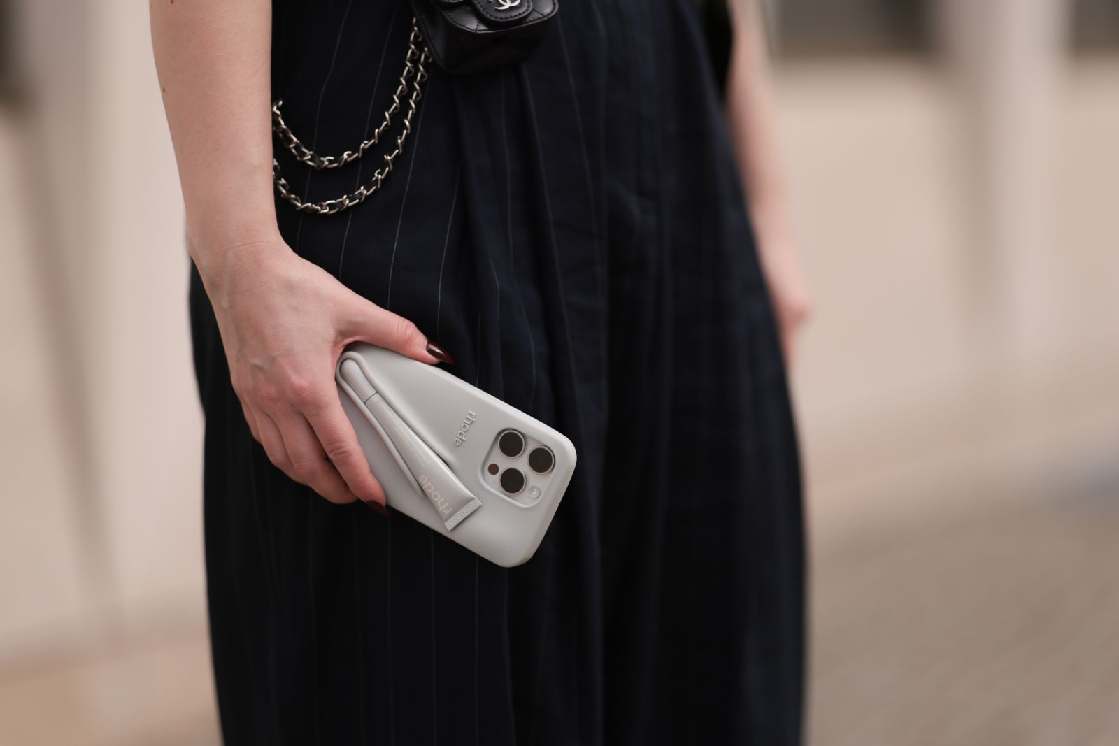 BERLIN, GERMANY - MARCH 31: Maria Barteczko seen wearing The Frankie Shop dark blue belted pinstriped oversized pants and Rhode by Hailey Bieber iPhone grey silicon case, on March 31, 2024 in Berlin, Germany. (Photo by Jeremy Moeller/Getty Images)