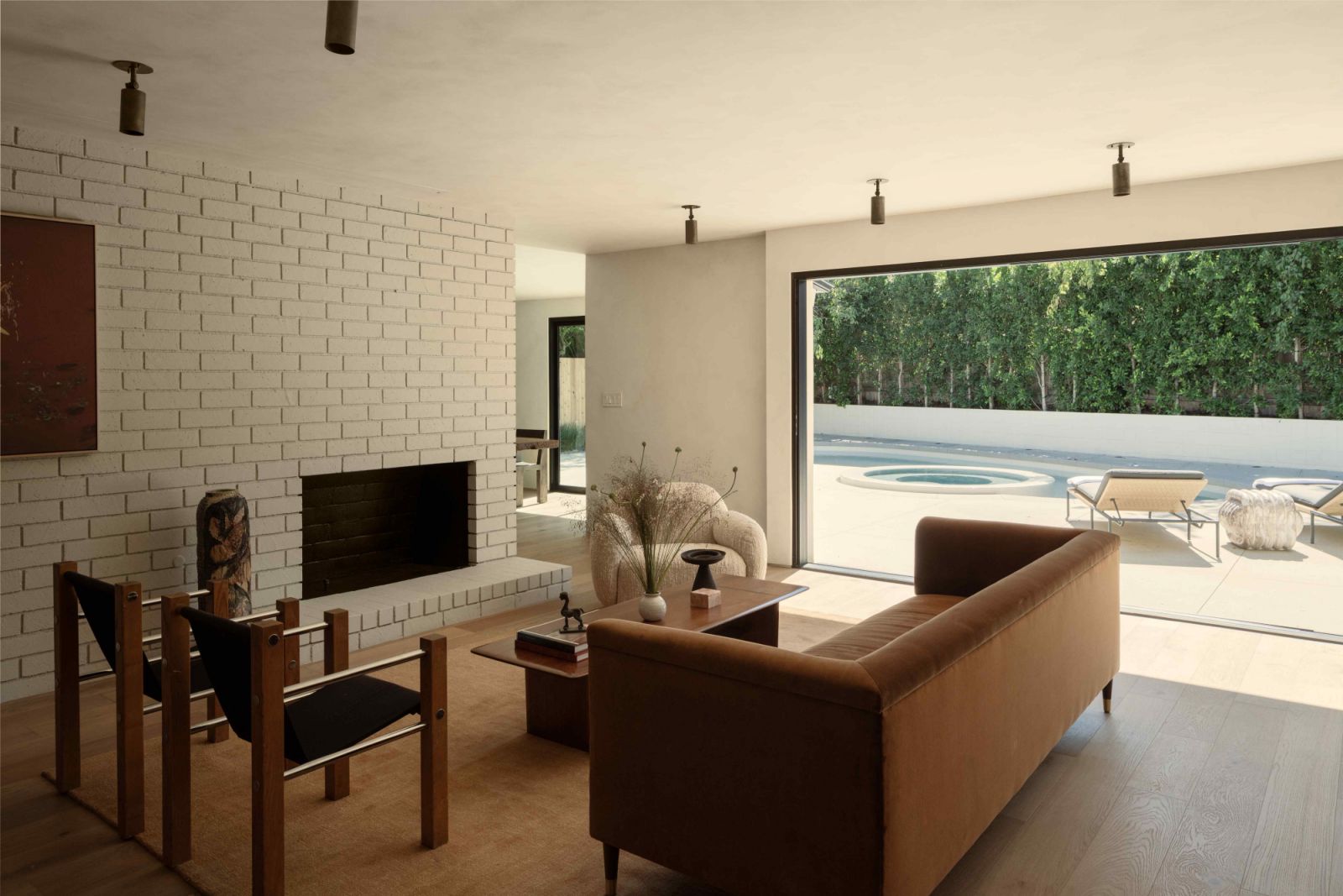 Expansive walls of pocketing doors allow seamless indoor-outdoor connection with nature