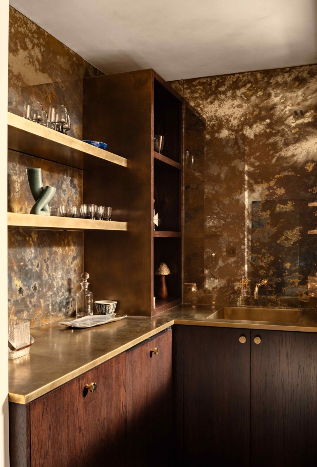 The elegant bar with marble backsplashes and gold accents