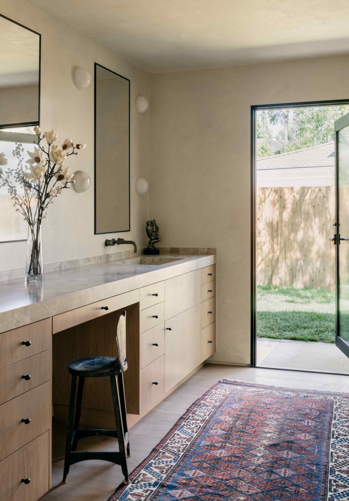 The primary bathroom opens into the private side yard
