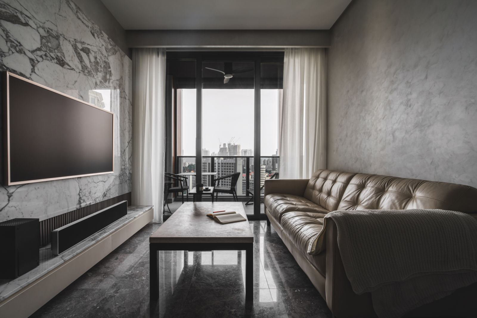 The living room of this bachelor pad plays up the beauty of natural stone