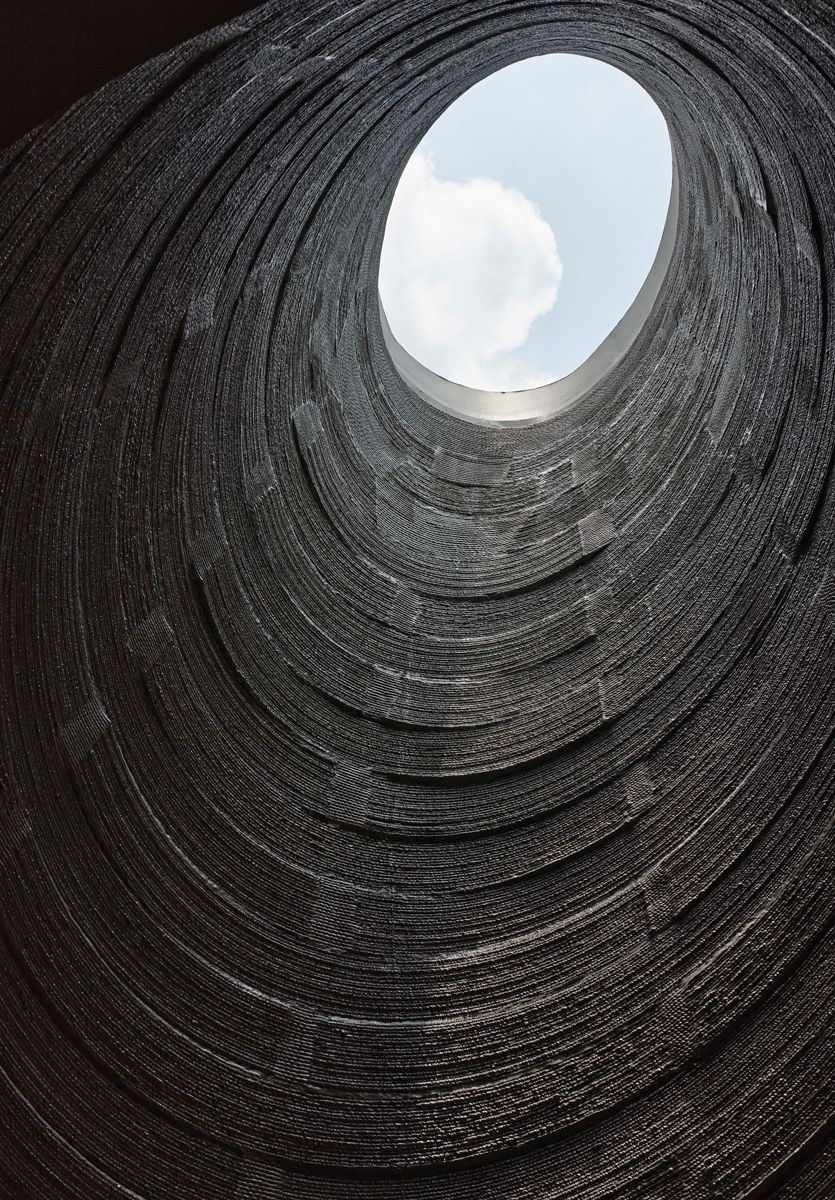 Looking up into the six-metre-tall oculus, the concentric 3D-printed layers frame the sky above and embody the poetic potential of additive construction