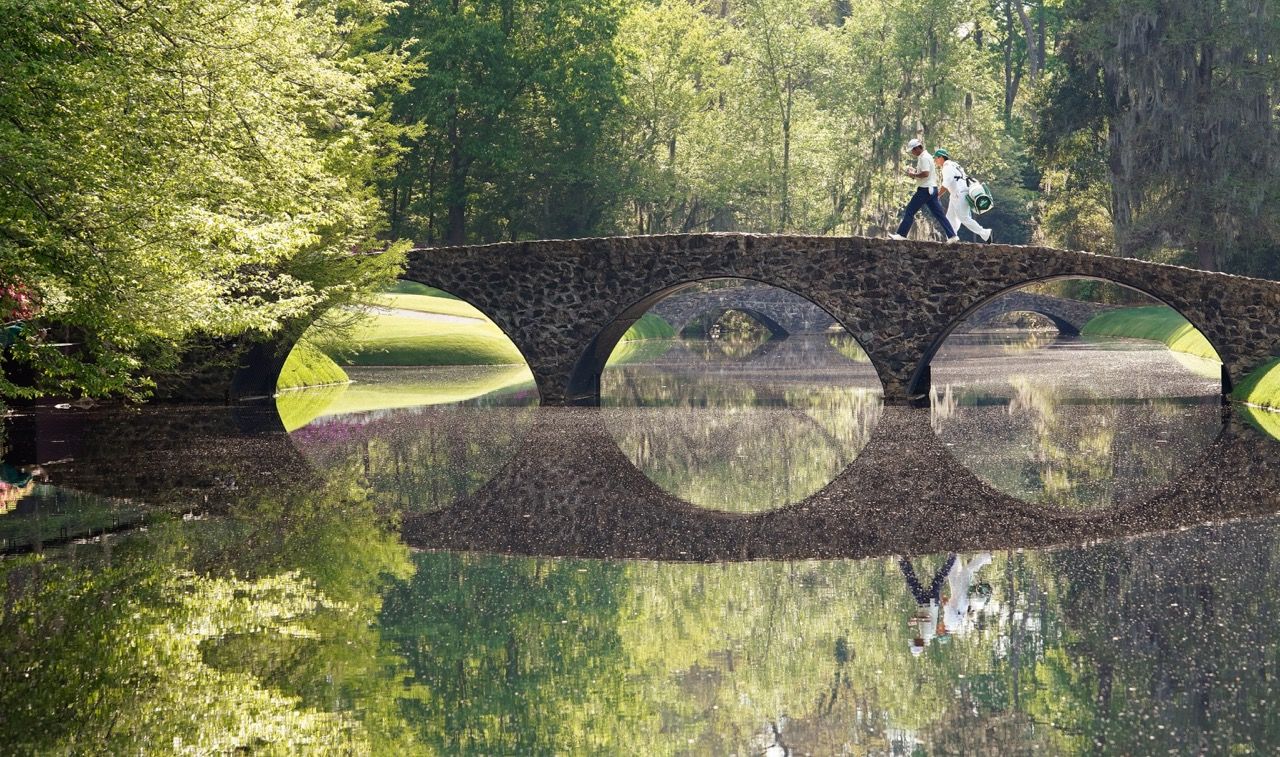 Hideki Matsuyama of Japan walks over the Hogan Bridge on No. 12 during the final round of the Masters at Augusta National Golf Club, Sunday, April 11, 2021.