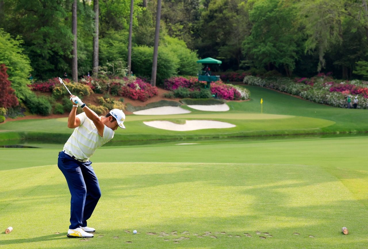 Hideki Matsuyama of Japan plays a stroke from the No. 12 tee during the final round of the Masters at Augusta National Golf Club, Sunday, April 11, 2021.
