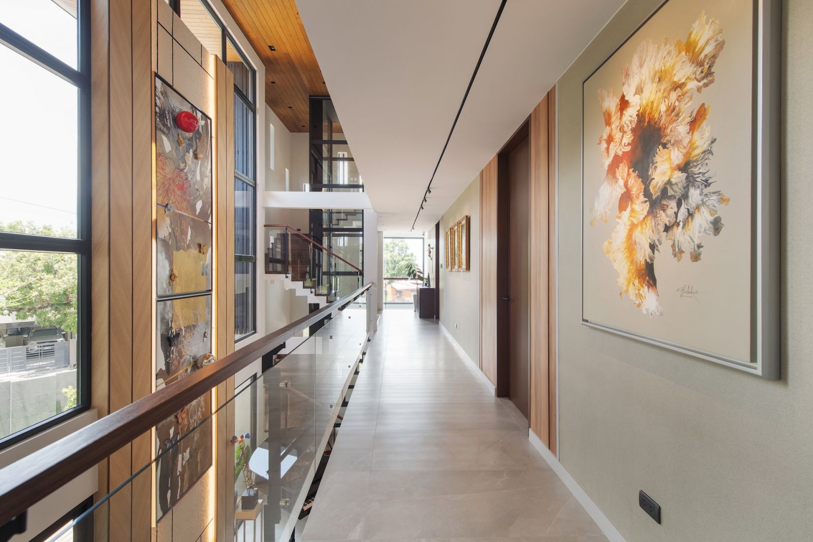 The art-filled hallway of this Alabang, Metro Manila home designed by Rock Robins