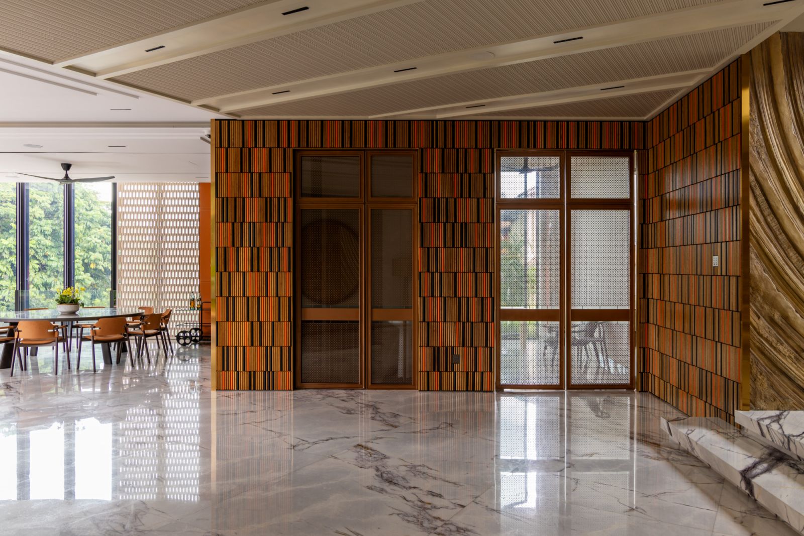 Large-format patterned tiles from China bring kinetic energy to the interior spaces, complementing the eclectic furniture selection that range from Roche Bobois’s curvy sofa to Stefano Giovannoni’s refined dining table