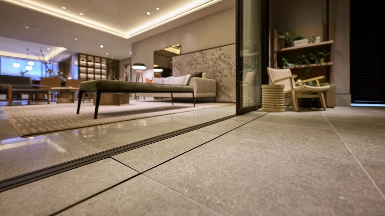 Living area flooring detail showing flush transitions and wide corridors, part of the accessibility features including unobstructed turning radii for mobility aids