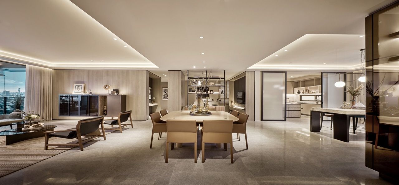 Units in Aetas Seputeh feature a 15.2-meter open-plan living-dining hall with lighting transitions and furniture composition defining spatial zones, featuring curated artwork and ambient lighting
