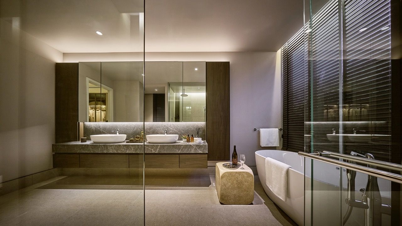 Master bathroom featuring freestanding tub with skyline view, double vanity with marble counter, and Grohe body jets, rain shower, and hand shower systems