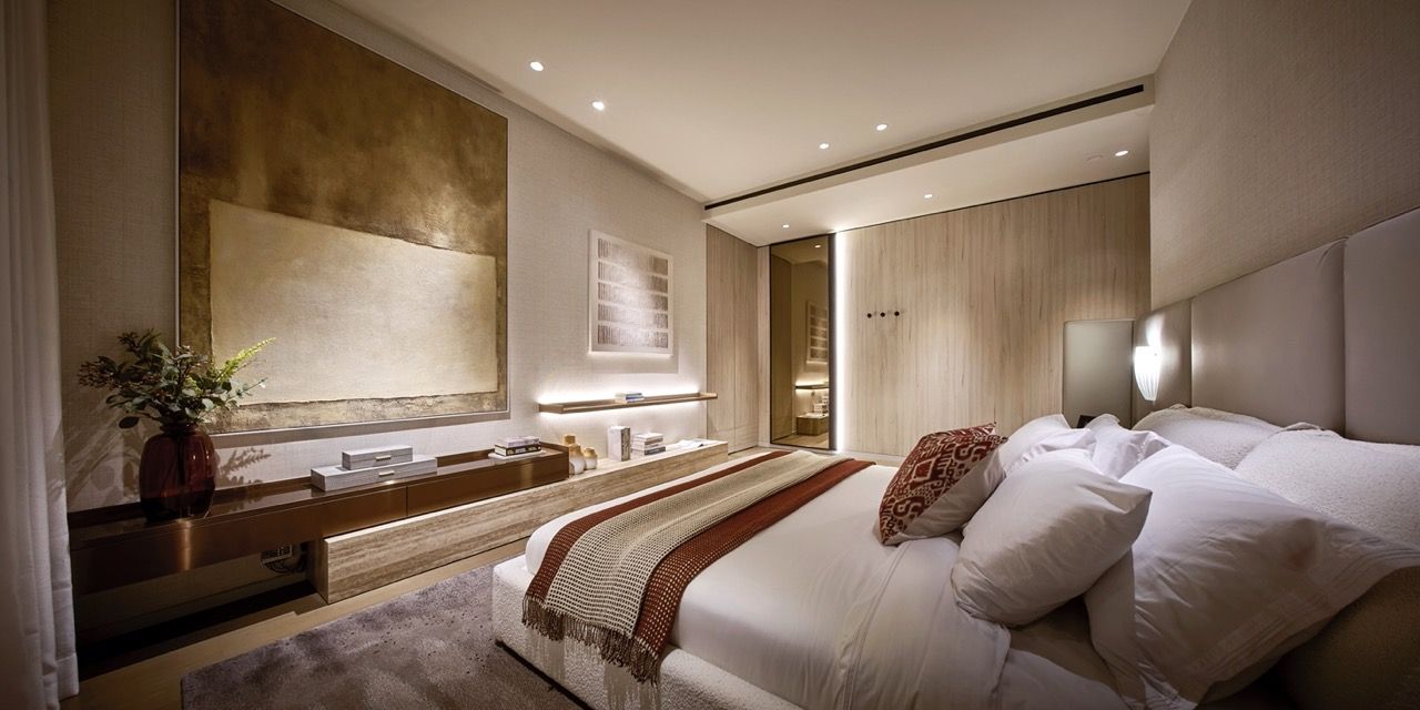 Master bedroom featuring dark tropical hardwood finishes and sliding corner doors opening to a balcony, part of Blu Water Studio's resort-inspired interior design