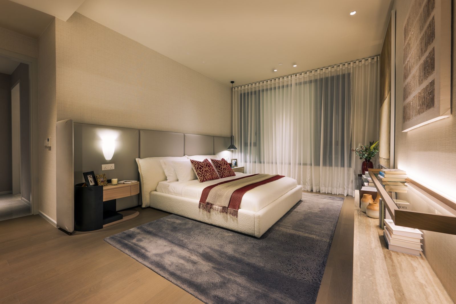 Master bedroom with north-facing orientation for optimal daylighting and thermal comfort, showcasing the warm palette of dark tropical hardwood and soft sand tones