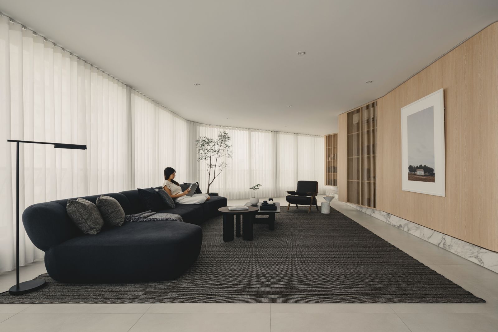 A grey rug adds contrast to the light-hued material palette in this Balmoral Tower home by 932 Design Group