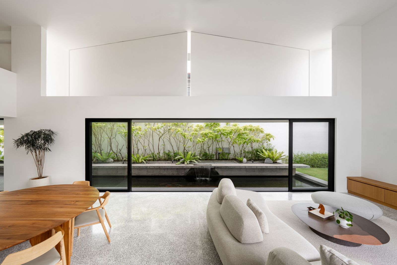Automated pivot panels above the koi pond entrance demonstrate an innovative bungalow privacy solution, appearing as solid architectural elements while providing flexible ventilation