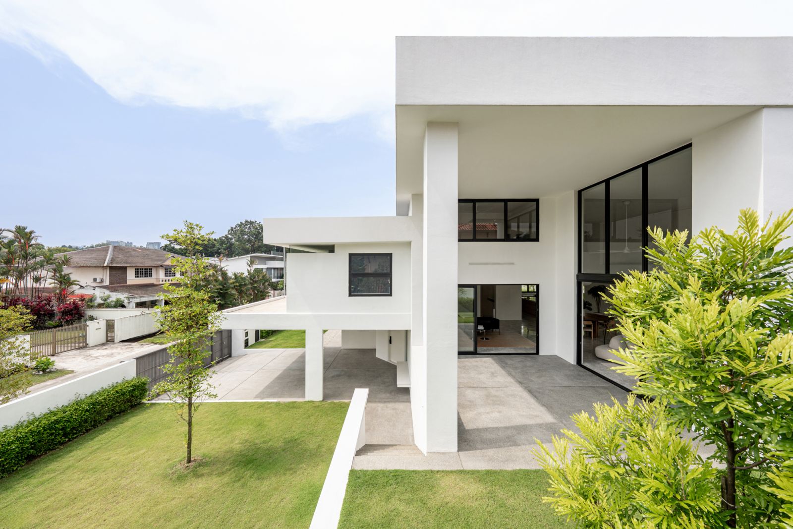 Aerial perspective of contemporary bungalow renovation demonstrates relationship with neighbouring traditional houses and extensive outdoor landscaping with mature trees