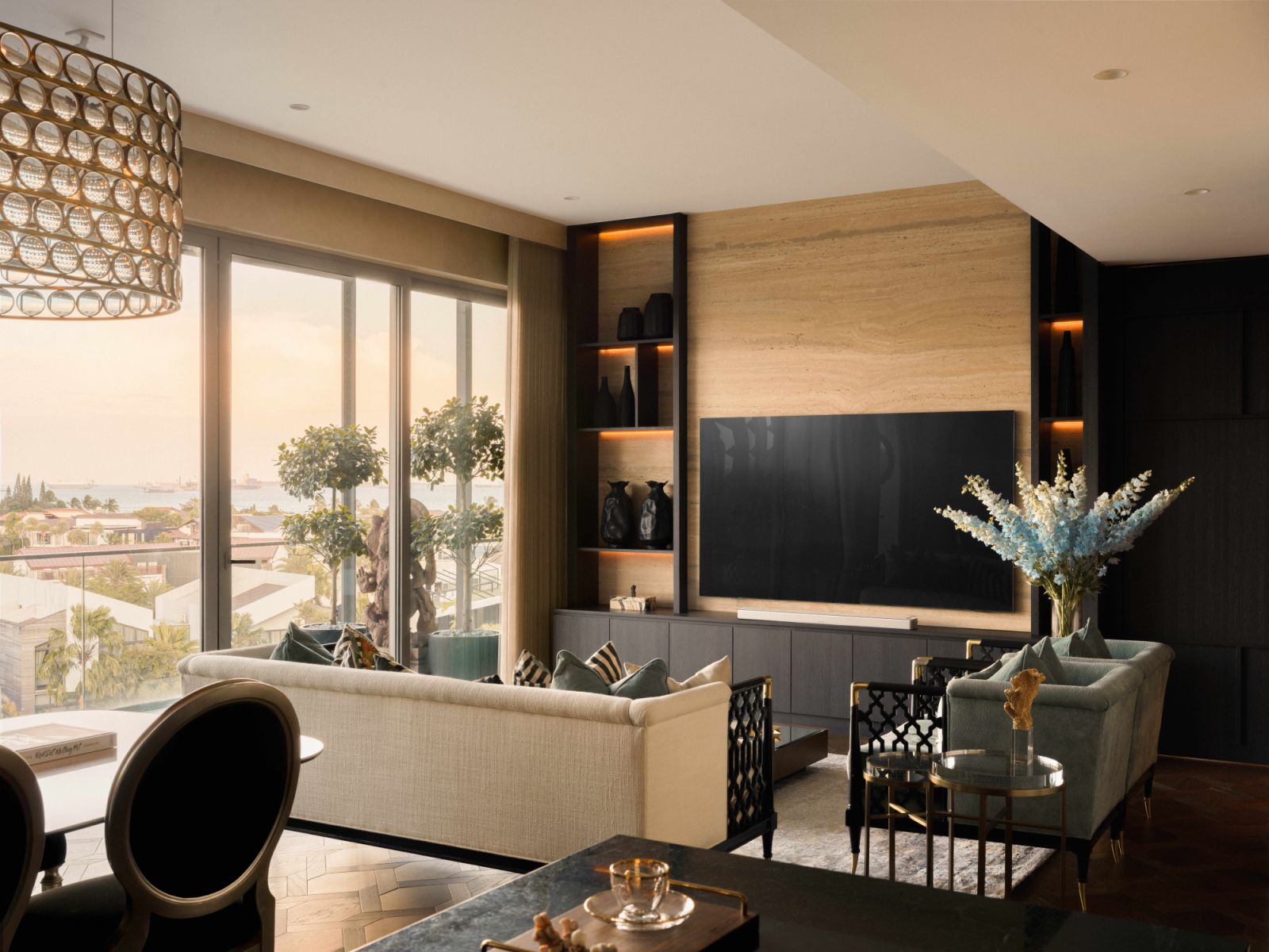 A travertine feature wall and gold- accented furnishings bring a luxurious touch to the living room