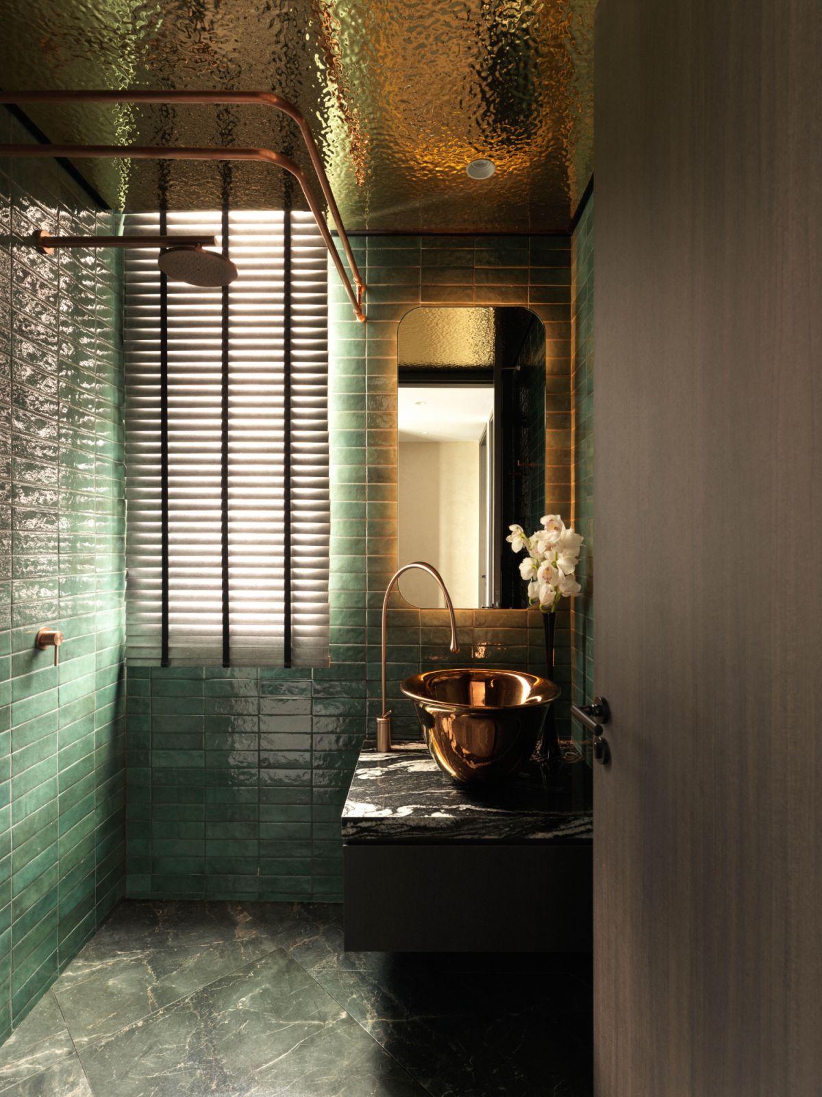 Shades of green and warm-toned metal finishes make for a striking powder room