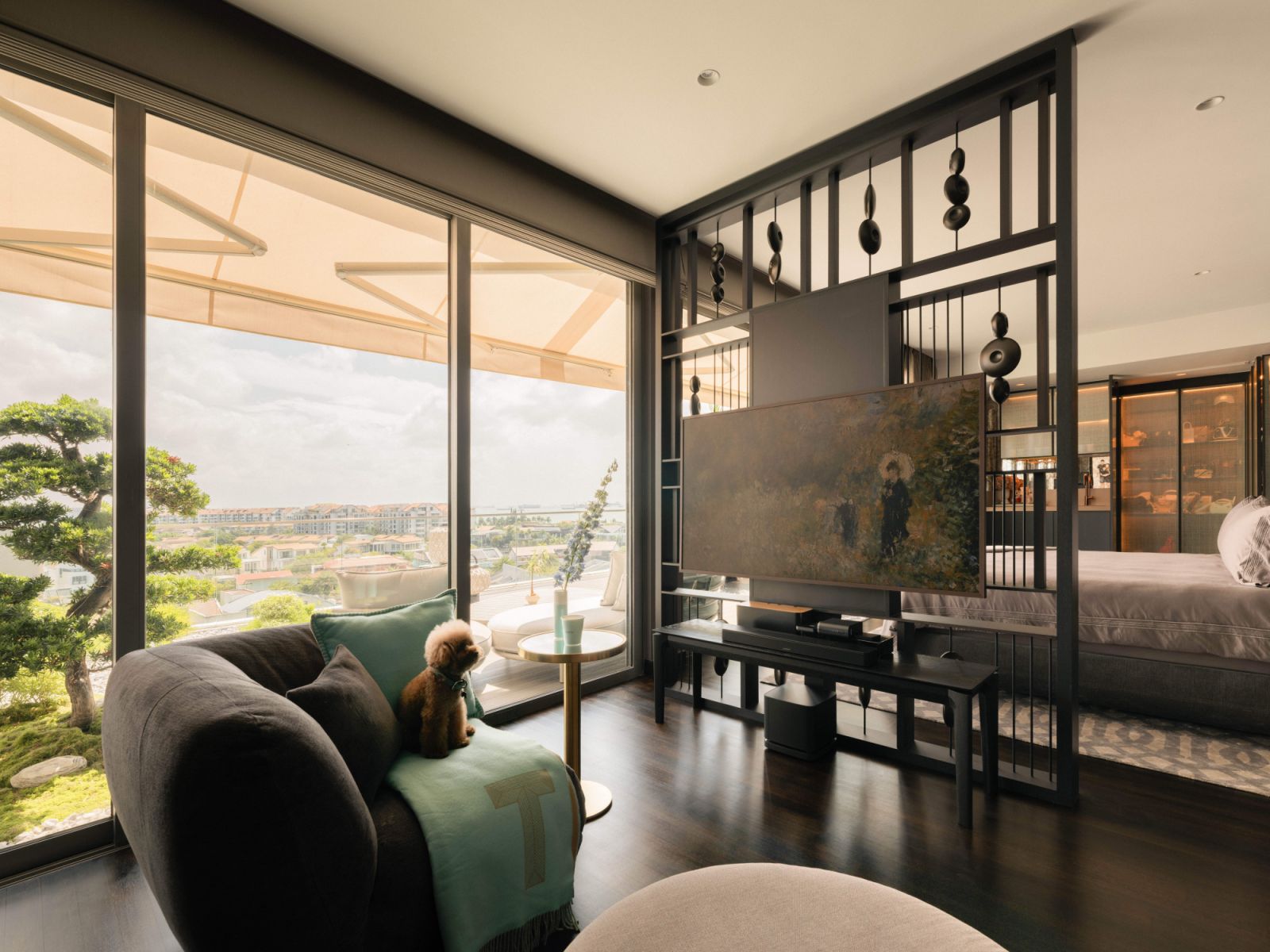 A custom divider evoking an abacus separates the sleeping and TV areas of the master suite