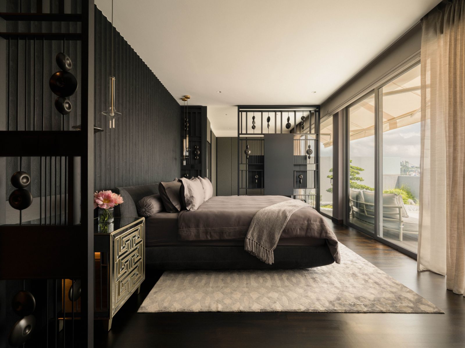 Inky wood finishes set a hushed, restful tone in the master bedroom