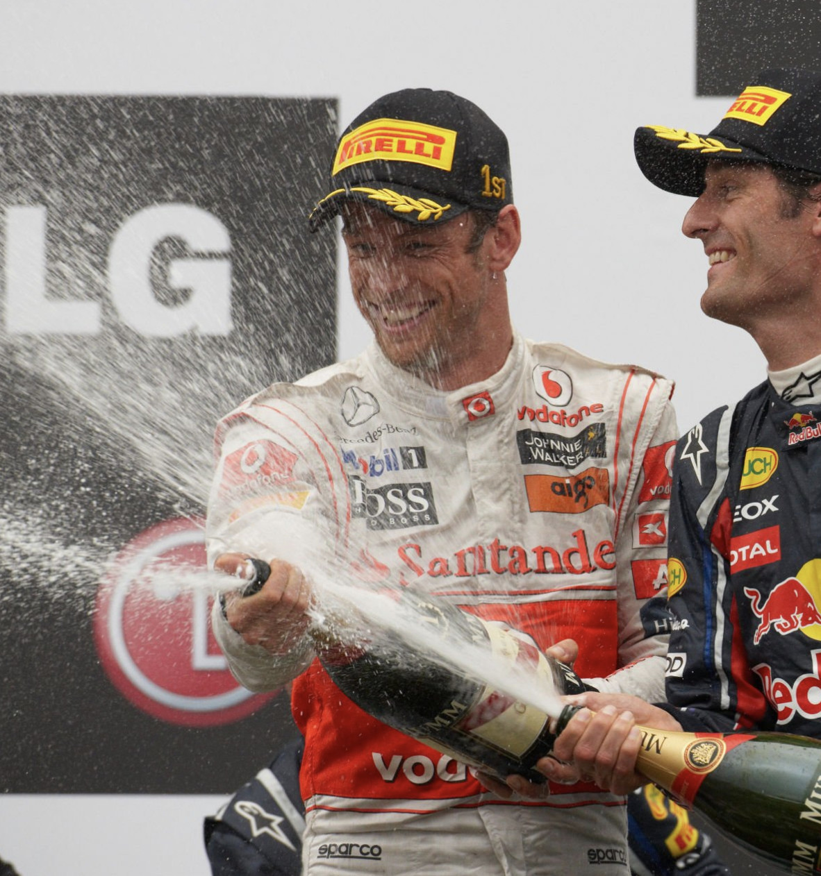 Jenson Button, 1st position, and Mark Webber, 3rd position, celebrate on the podium during the Canadian GP at Circuit Gilles-Villeneuve on June 12, 2011 in Circuit Gilles-Villeneuve, Canada.(Photo:Getty Images)