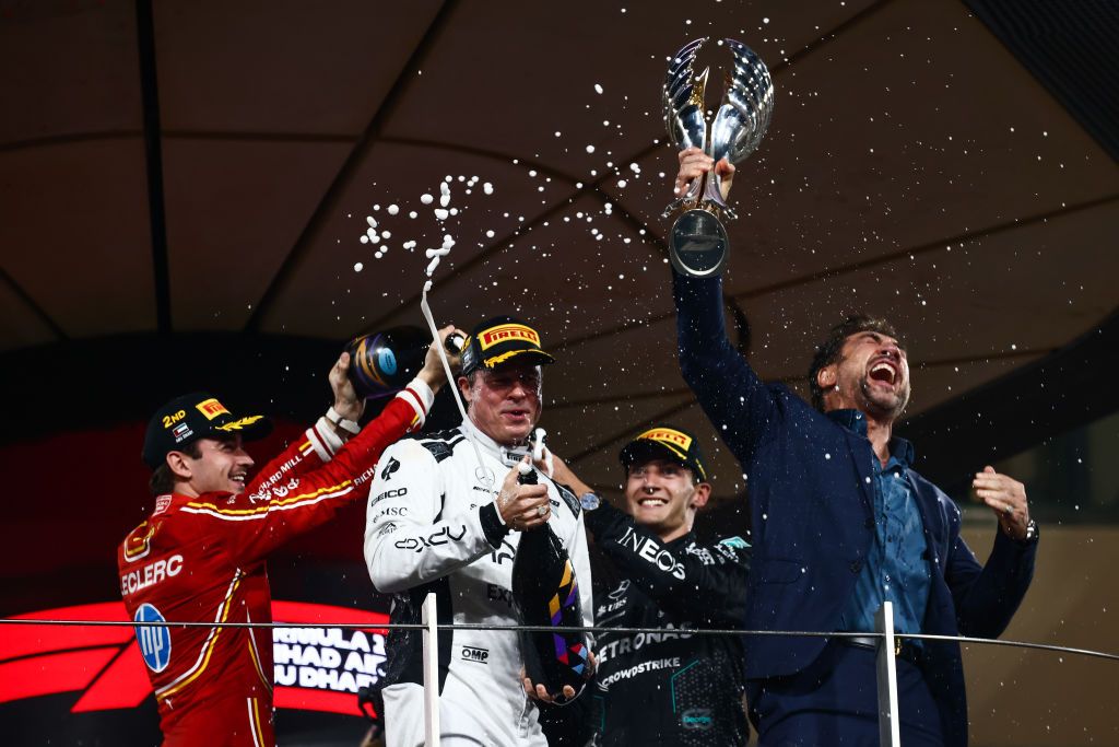 Charles Leclerc of Ferrari, George Russell of Mercedes, actor Javier Bardem and Brad Pitt, actor playing Sonny Hayes, a driver of the fictional Apex APXGP F1 team in the upcoming 'F1' movie directed by Joseph Kosinski, are filming a scene on the podium during Formula 1 Abu Dhabi Grand Prix at Yas Marina Circuit on December 8th, 2024 in Abu Dhabi, United Arab Emirates.(Photo:Getty Images)