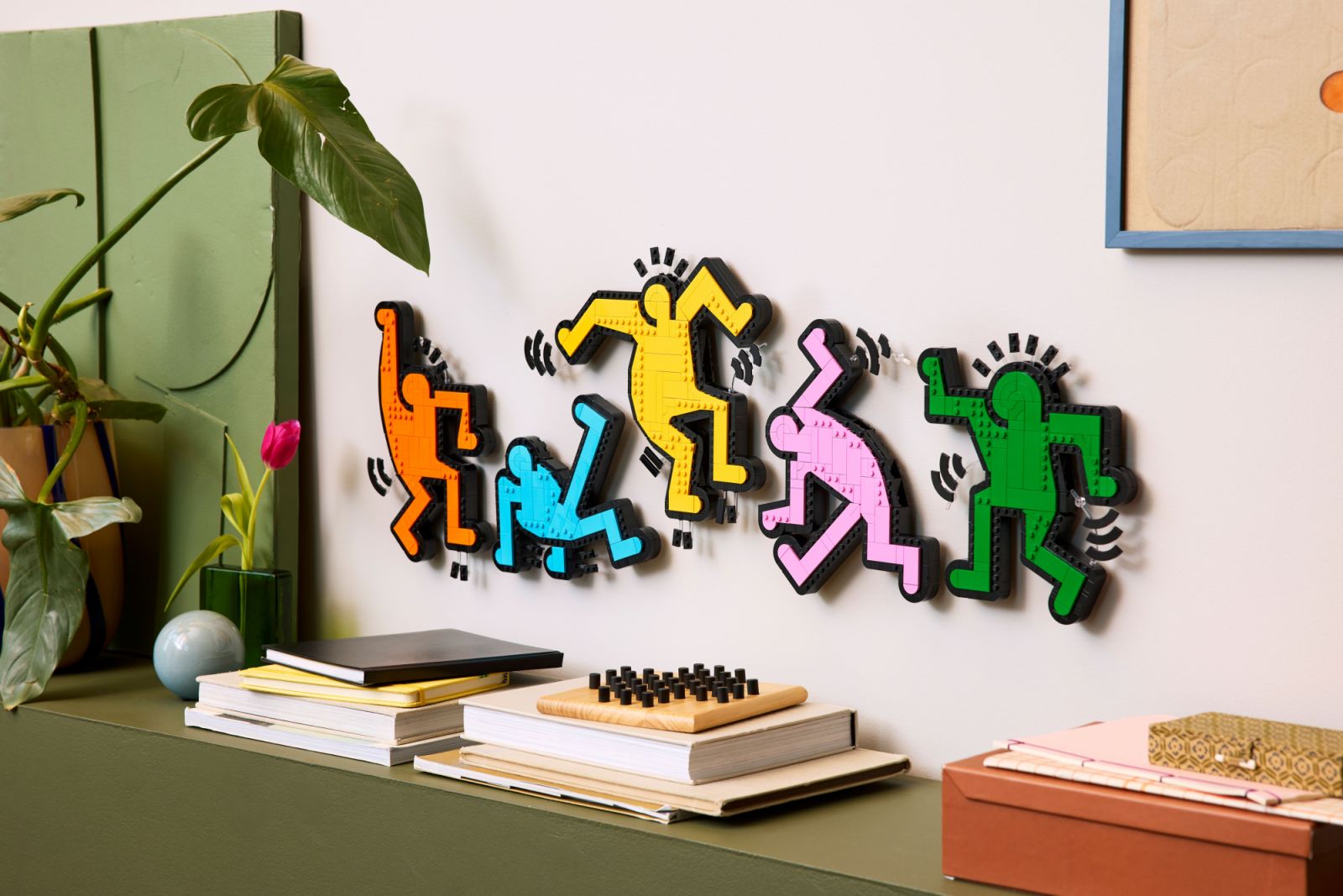 The Lego Art Keith Haring Dancing Figures set showcases the iconic pop art figures in vibrant colours. The 1,773-piece set captures Haring’s signature style with bold, graphic representations of his dancing figures in vibrant colours, including orange, blue, yellow, pink, and green