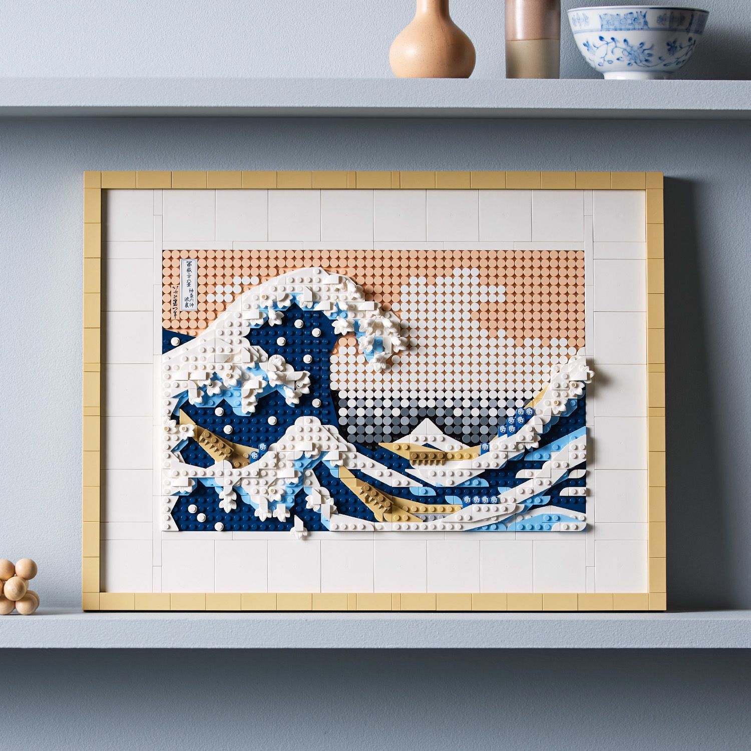 The Lego Art Hokusai The Great Wave set showcases Hokusai’s iconic The Great Wave off Kanagawa through layered shades of blue and white tiles that recreate the wave’s dramatic curling form and frothy crests with remarkable detail.