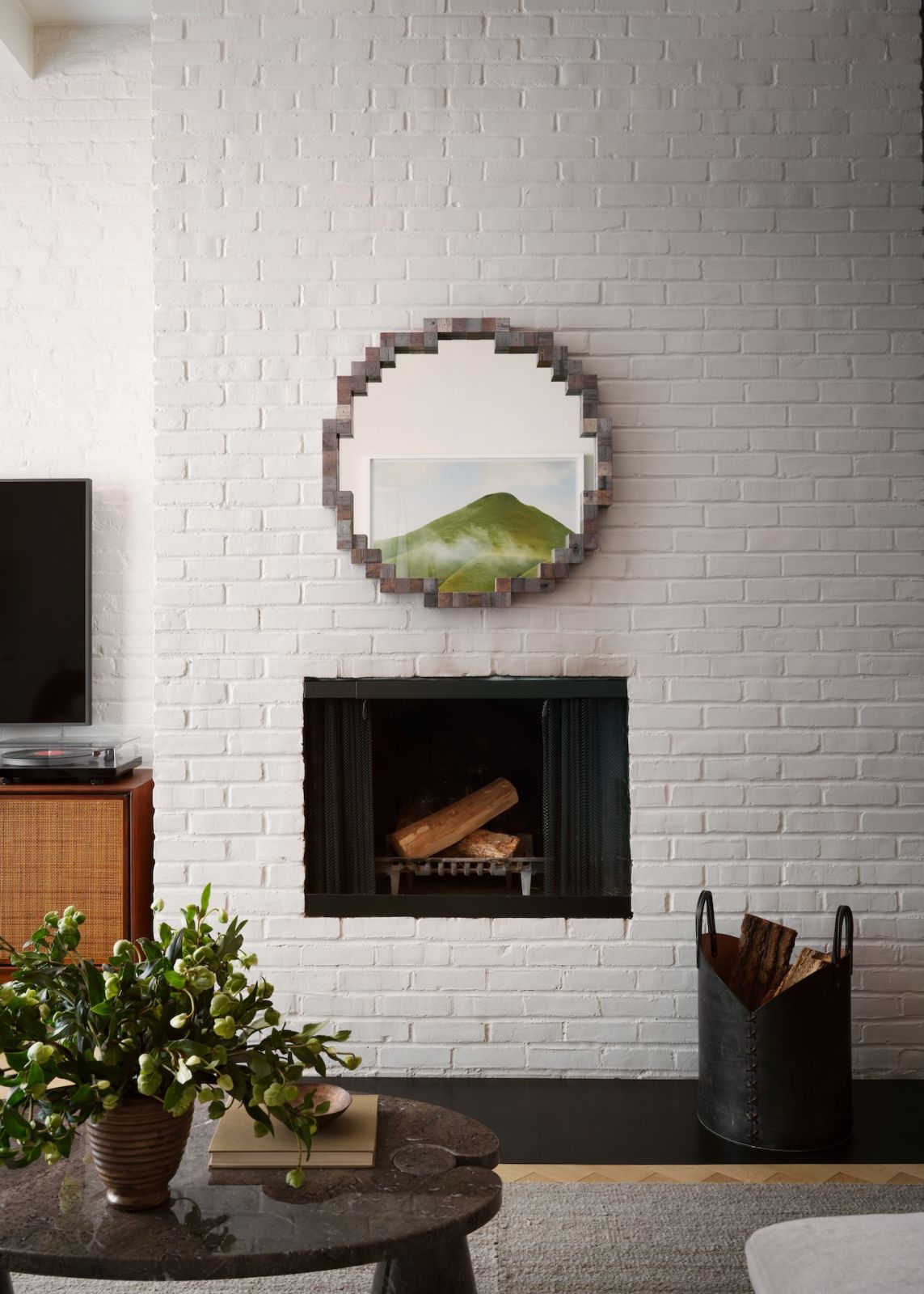 An exposed brick wall in the living room of a restored warehouse in the West Village, Manhattan, New York; the home was designed by Grisoro Studio