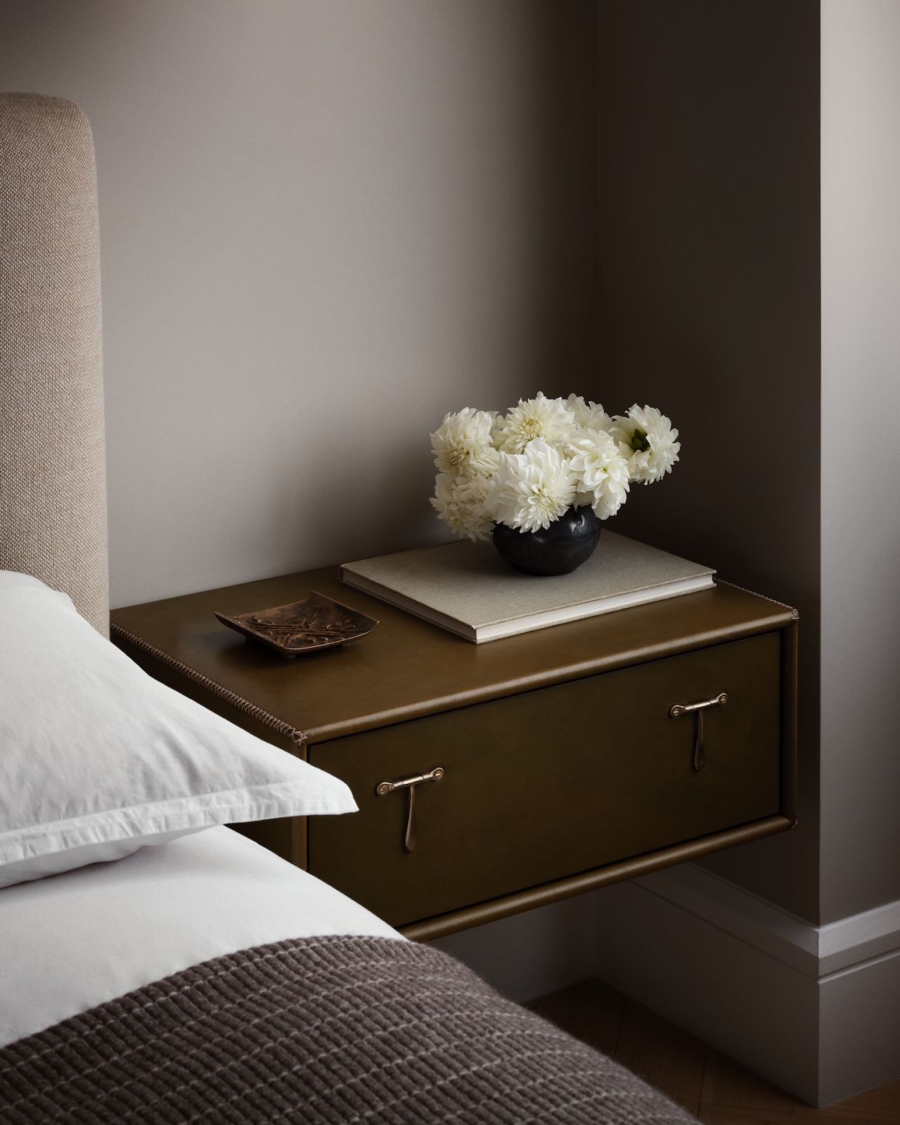 The craftsmanship is in the smallest details; the bedside table of the guest bedroom in a restored warehouse in the West Village, Manhattan, New York; the home was designed by Grisoro Studio