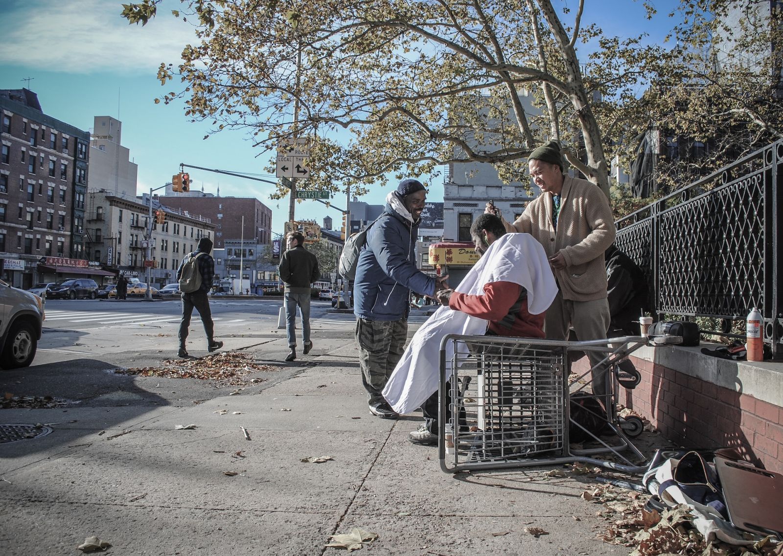 Hairstylist Mark Bustos giving a haircut on the streets of New York