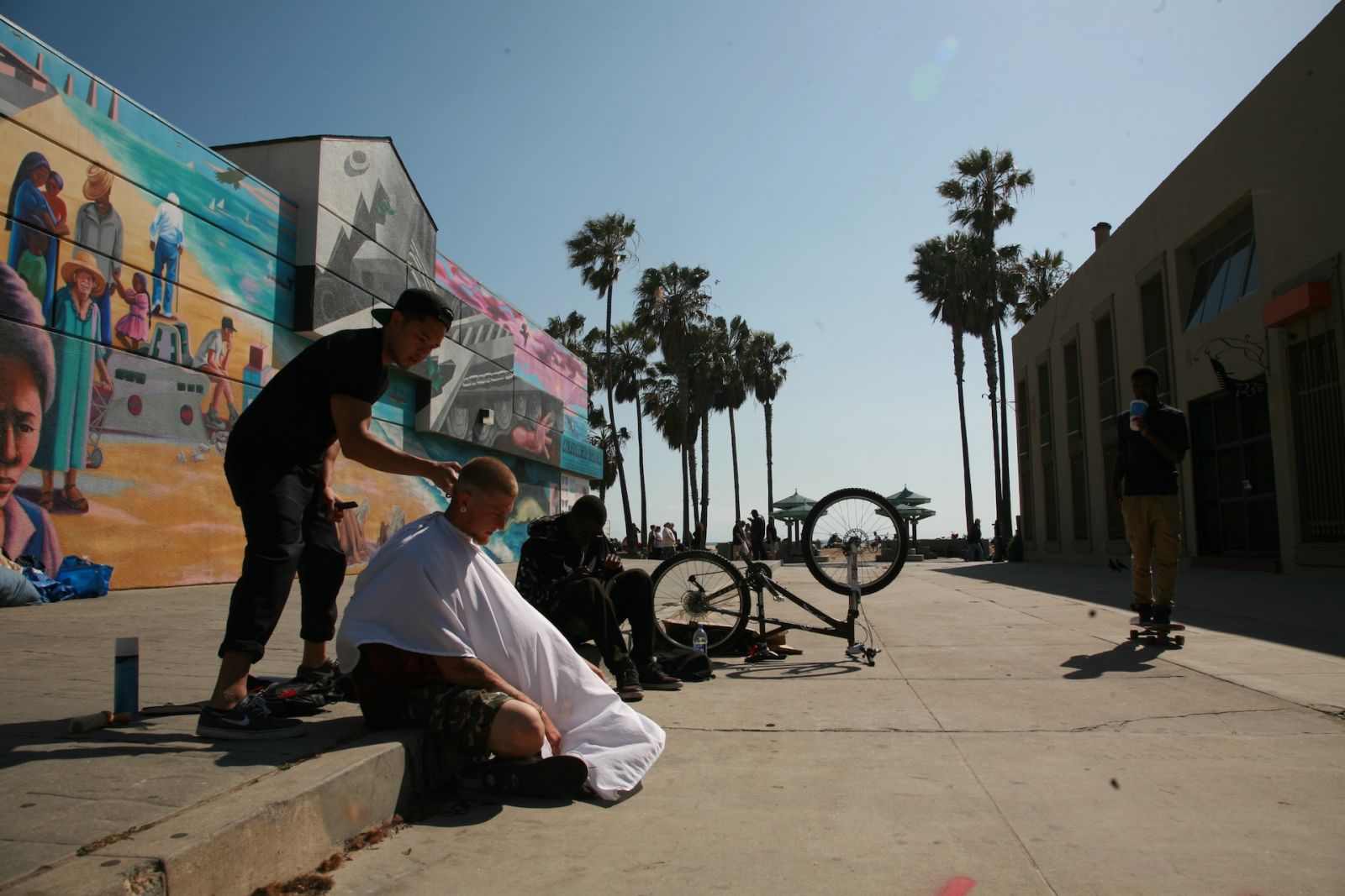 Hairstylist Mark Bustos giving a haircut on the streets of New York