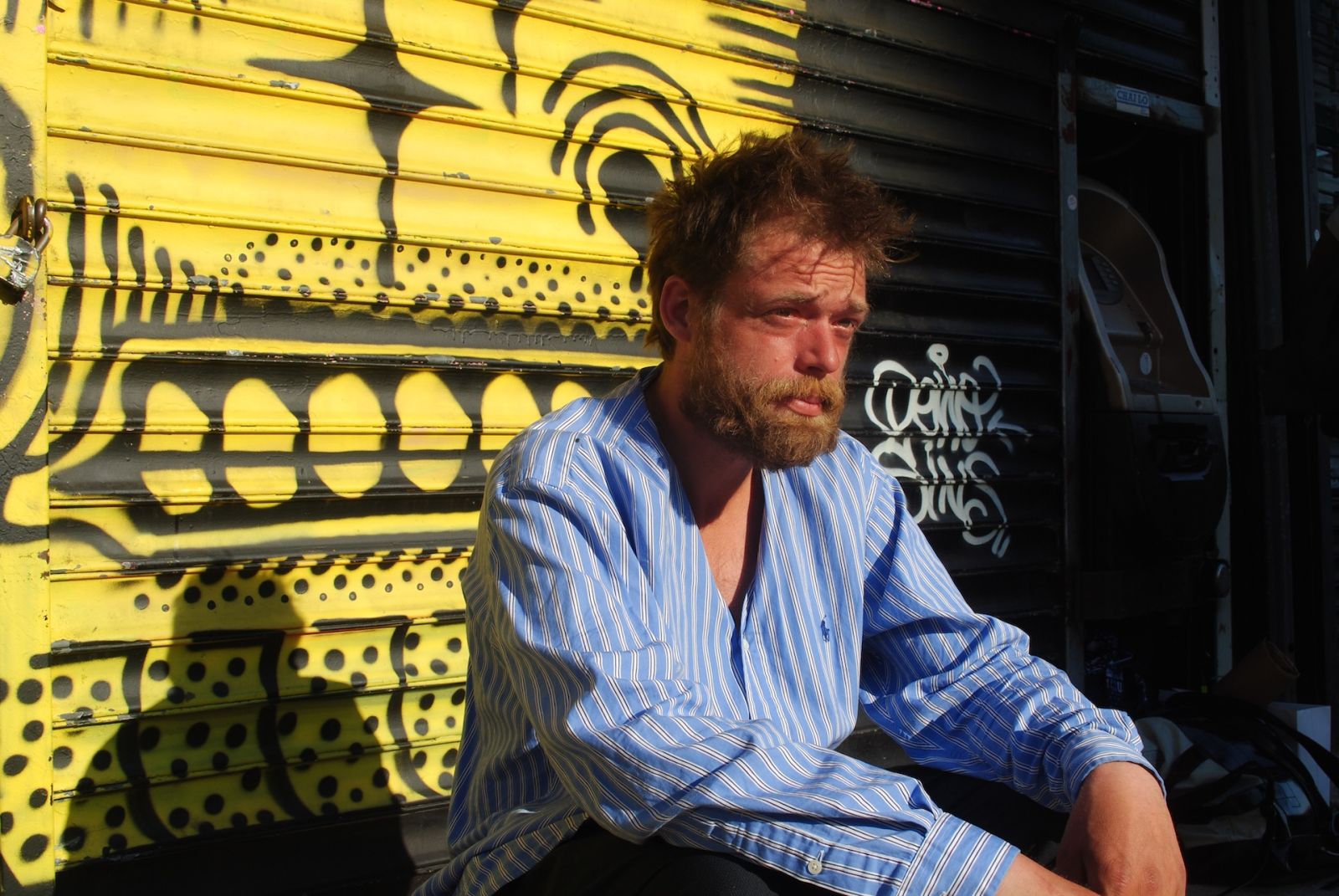 Hairstylist Mark Bustos giving a haircut on the streets of New York