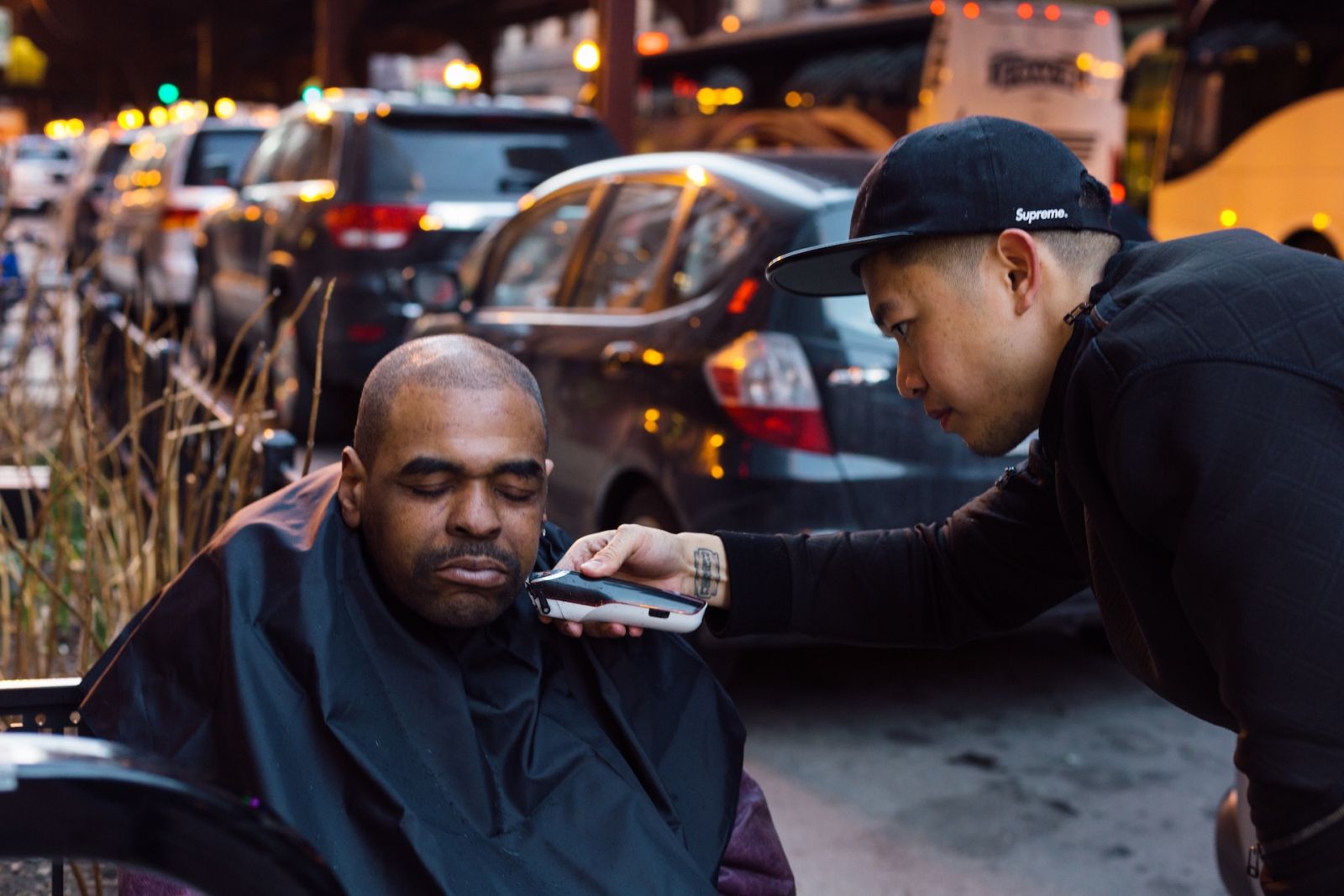 Hairstylist Mark Bustos giving out free haircuts on the streets of New York