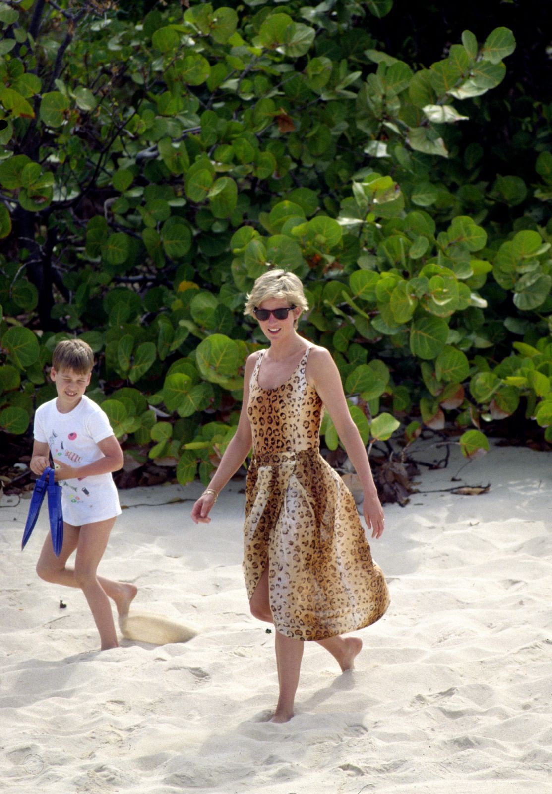 Diana, Princess of Wales with Prince William on a beach holiday in the British Virgin Islands. She wears a leopard-print swimsuit by Jantzen (Photo: Tim Graham Photo Library via Getty Images)