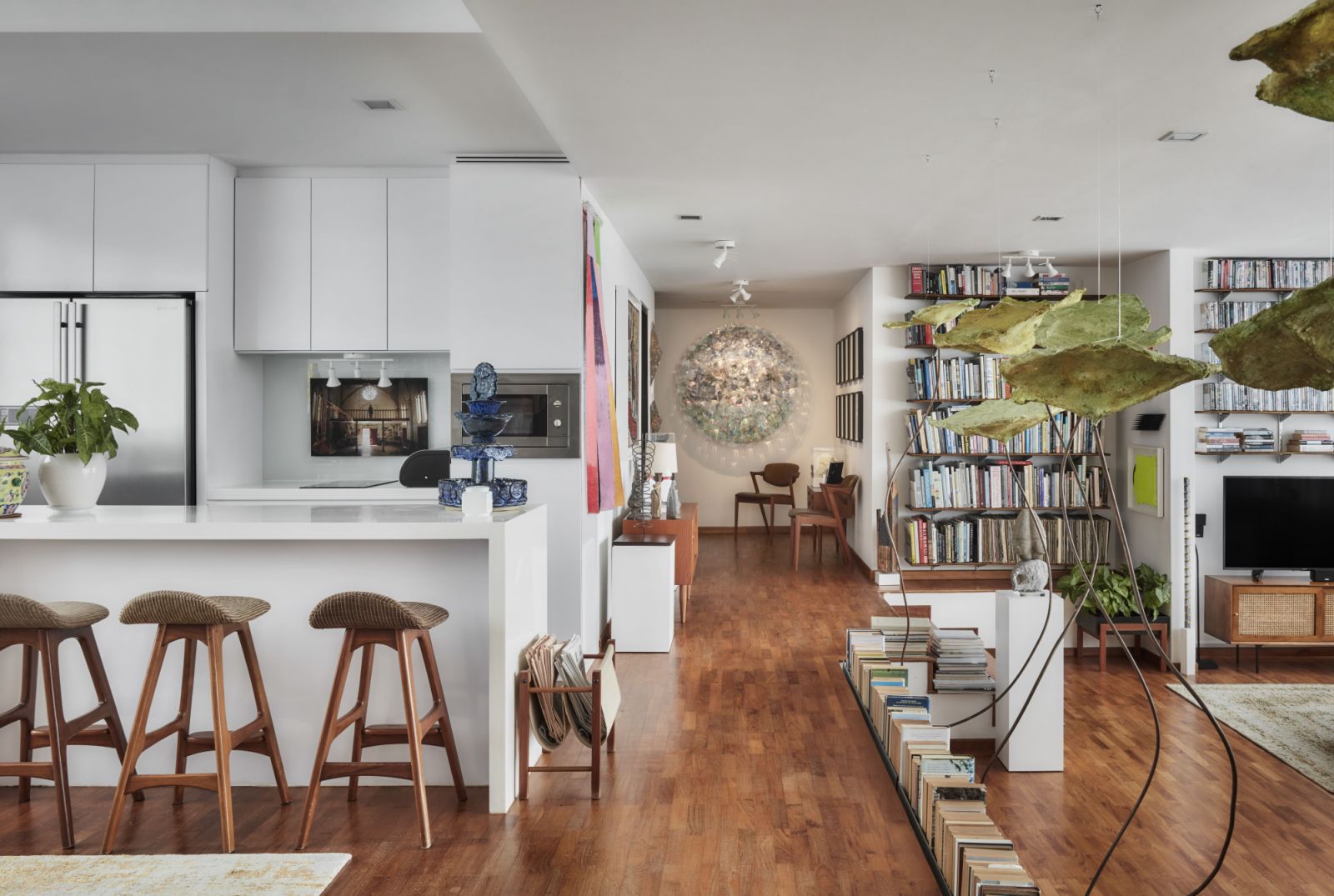 A view of the hallway, with the kitchen and dining area to the left and the living room to the right