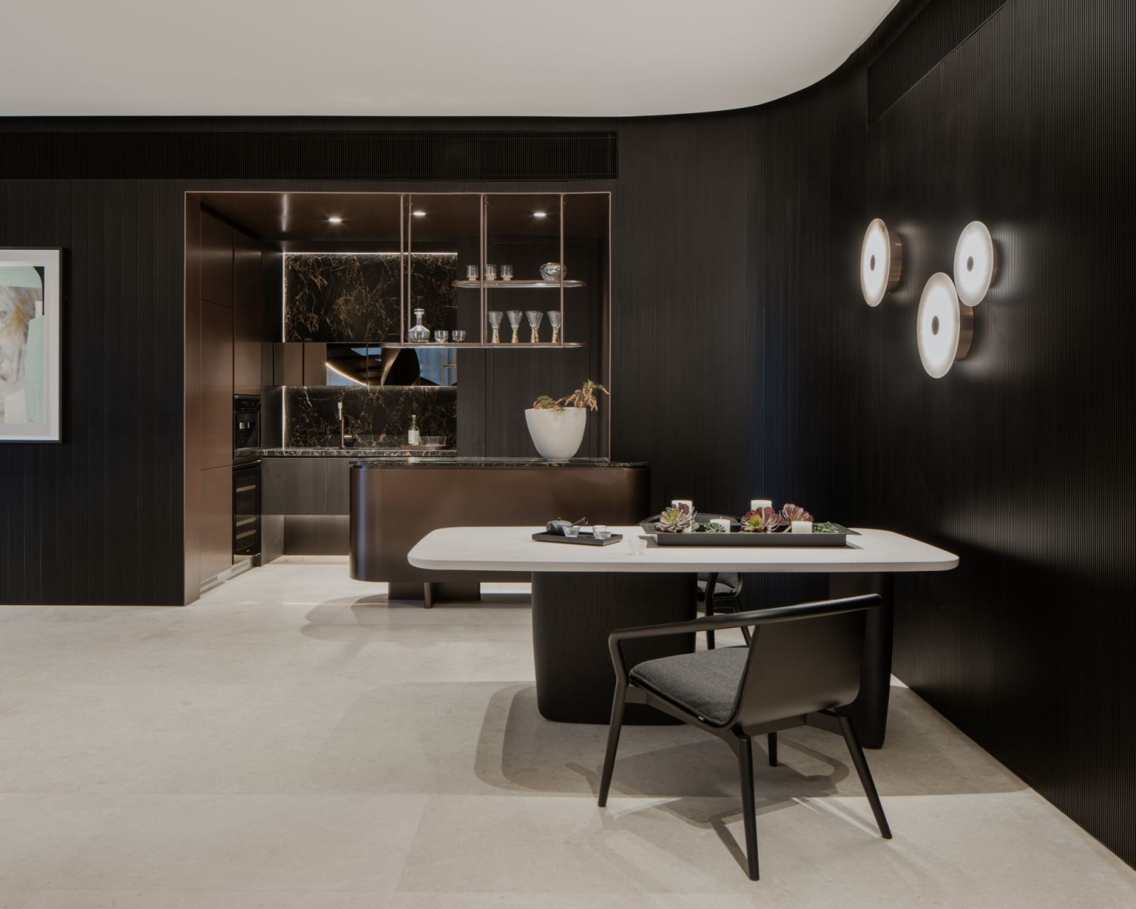 The wall’s dark finish lends a sense of intimacy