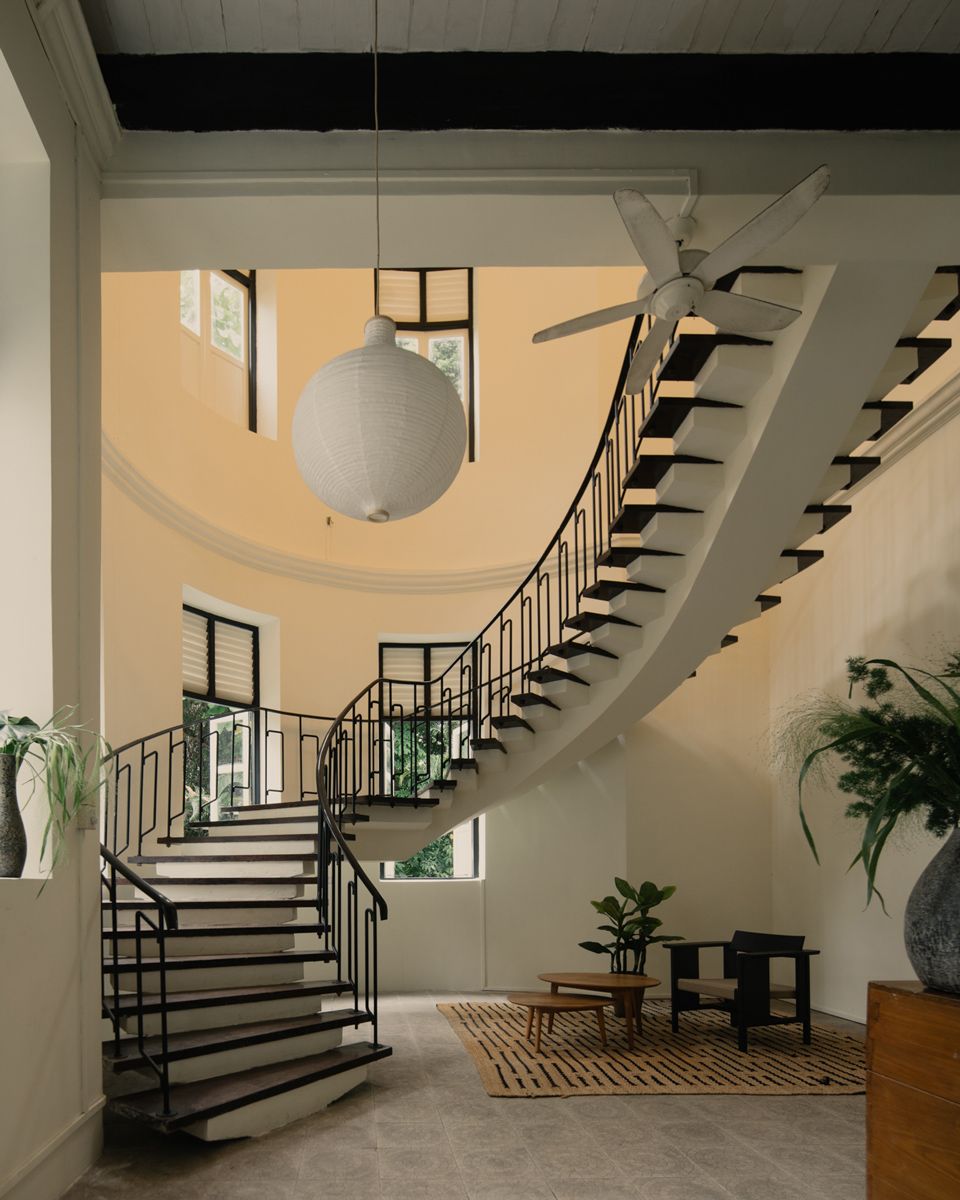 The elegantly restored staircase leading to the second floor of the Pender Road mansion, where the serving priest and his family reside
