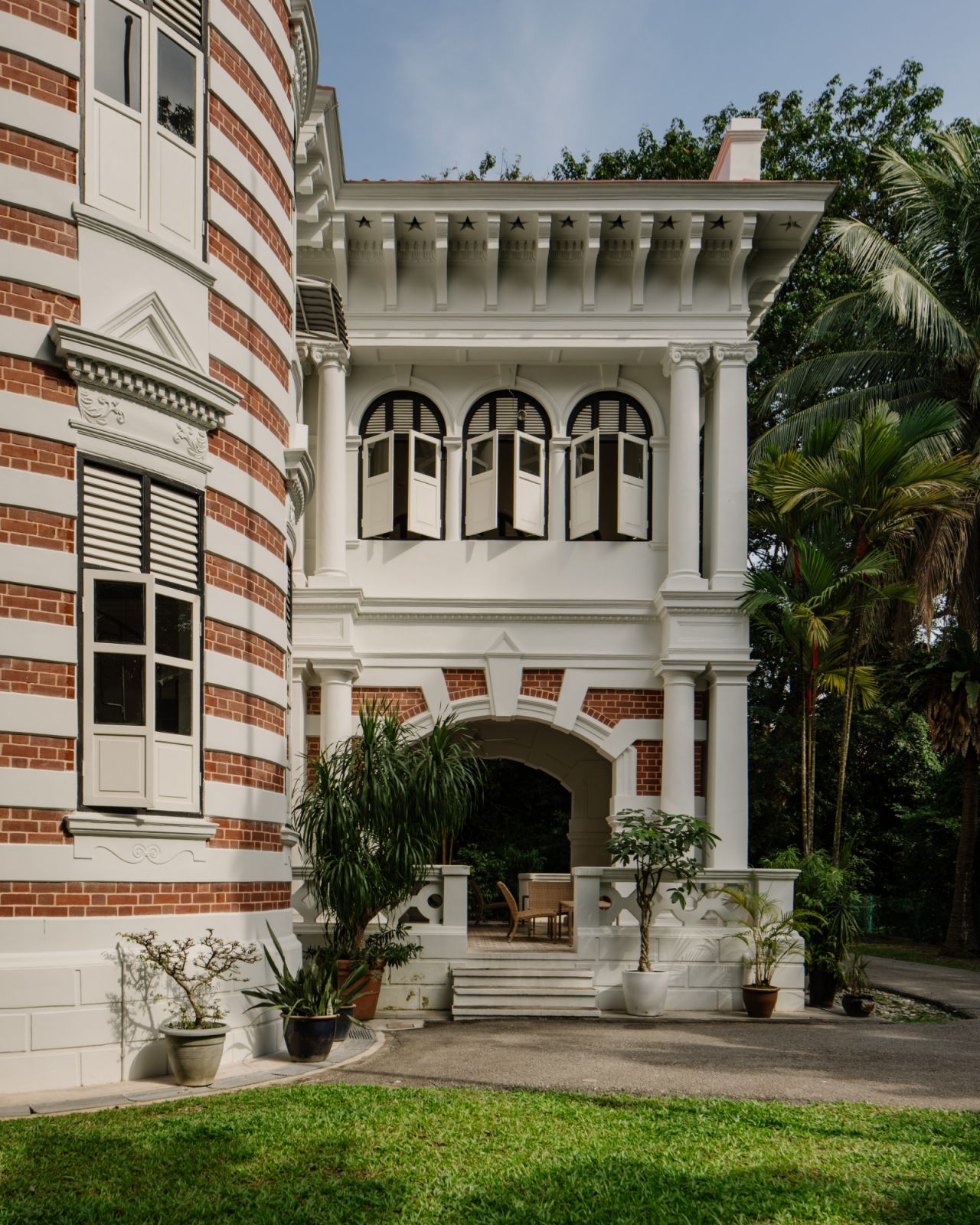 The facade of the Pender Road mansion combines disparate design influences such as louvre windows and star-shaped cornice openings with Ionic and Tuscan columns