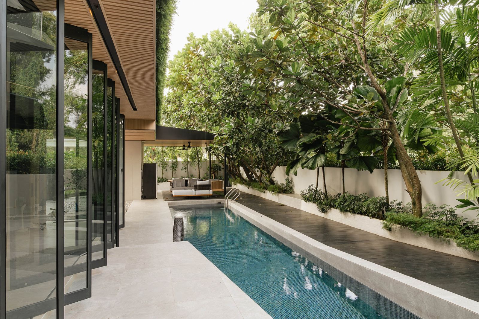 The pool area is surrounded by greenery