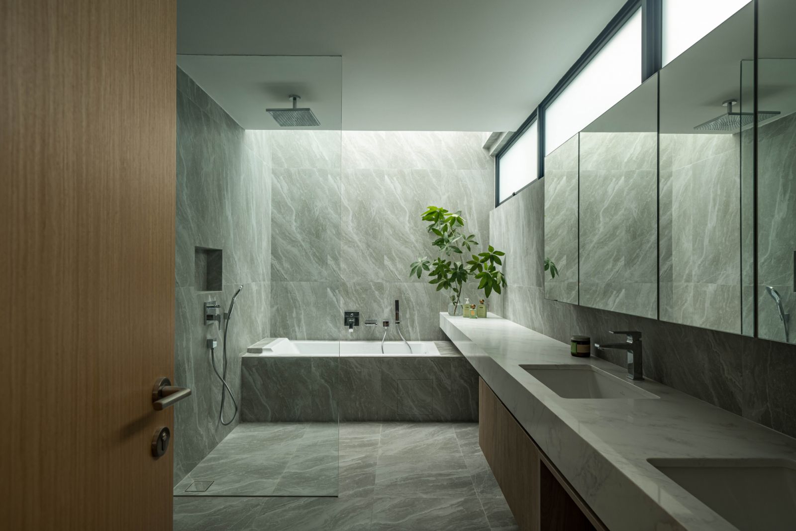 The master bathroom incorporates a double-sink vanity and a bathtub under a skylight