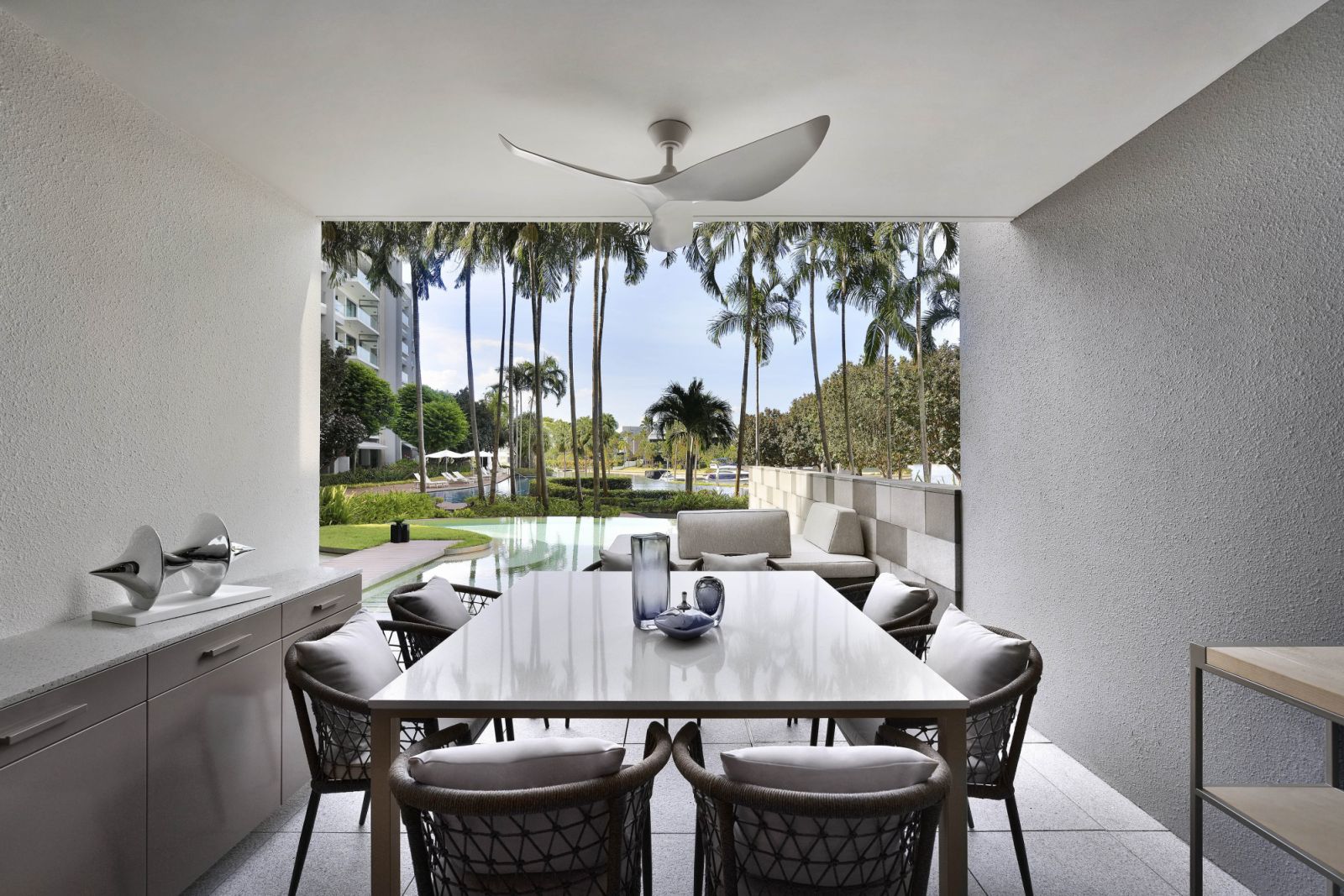 One of the perks of a ground-level unit: an al fresco dining zone with a view of and direct access to the pool