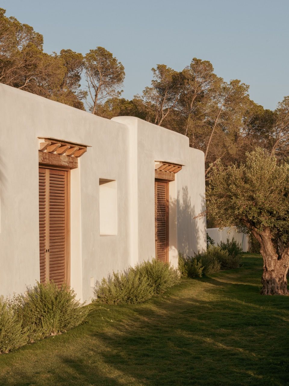 Exposed wooden beam ceilings and traditional wooden shutters maintain the essence of finca architecture whilst incorporating modern proportions and clean detailing