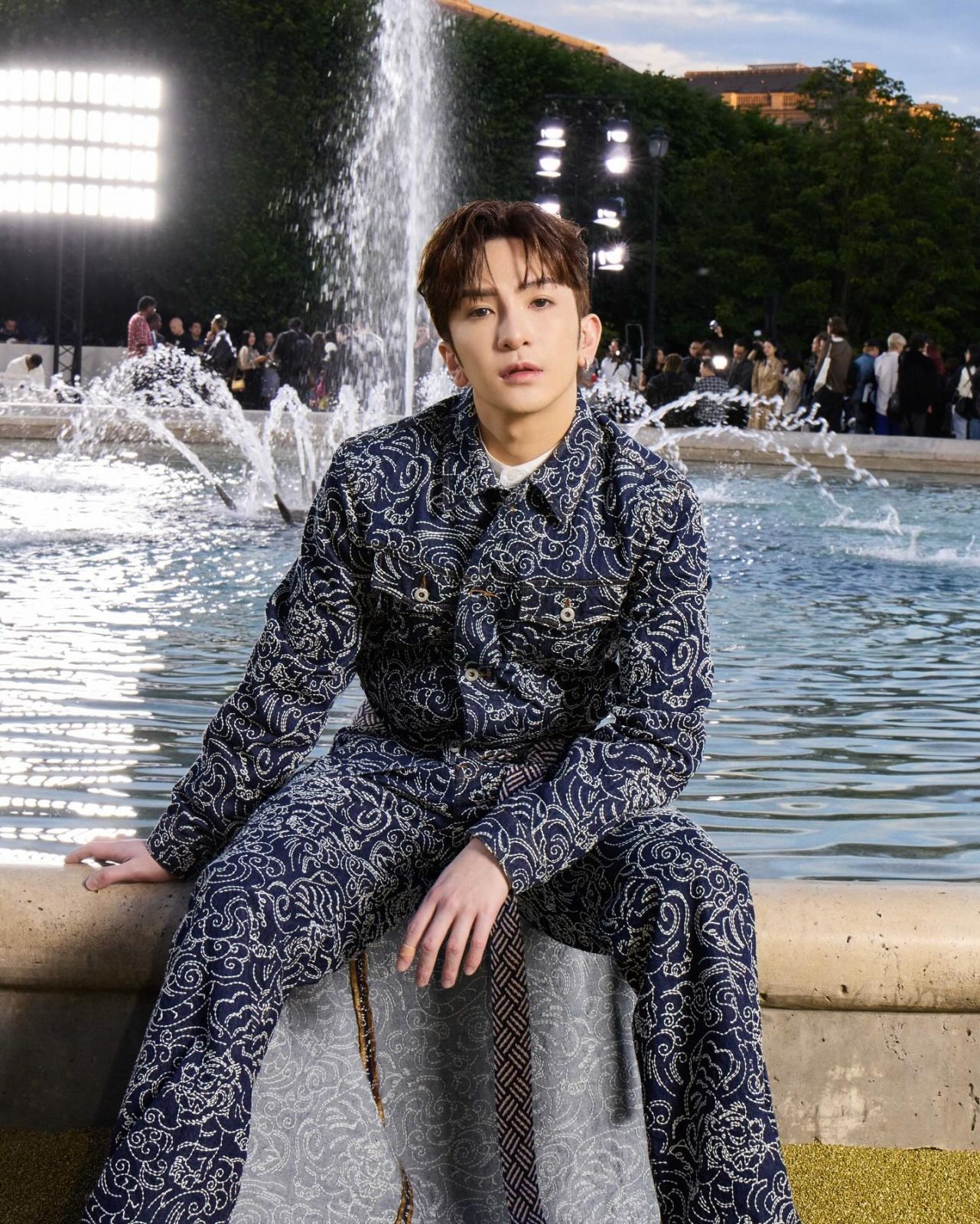 Anson Lo at Jardin du Palais Royal wearing Kenzo Star Tiger denim jacket