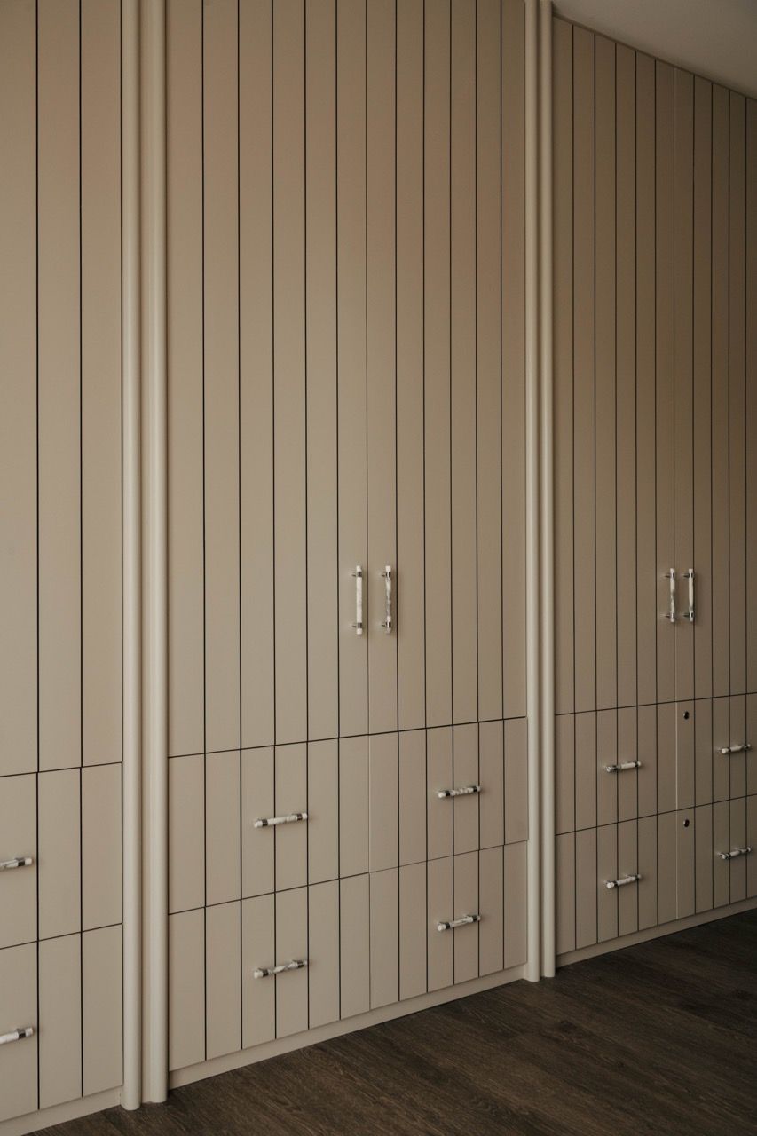 Custom-made natural veneer cabinetry and wall panels throughout the home showcase matte finishes and grounded and warm textures