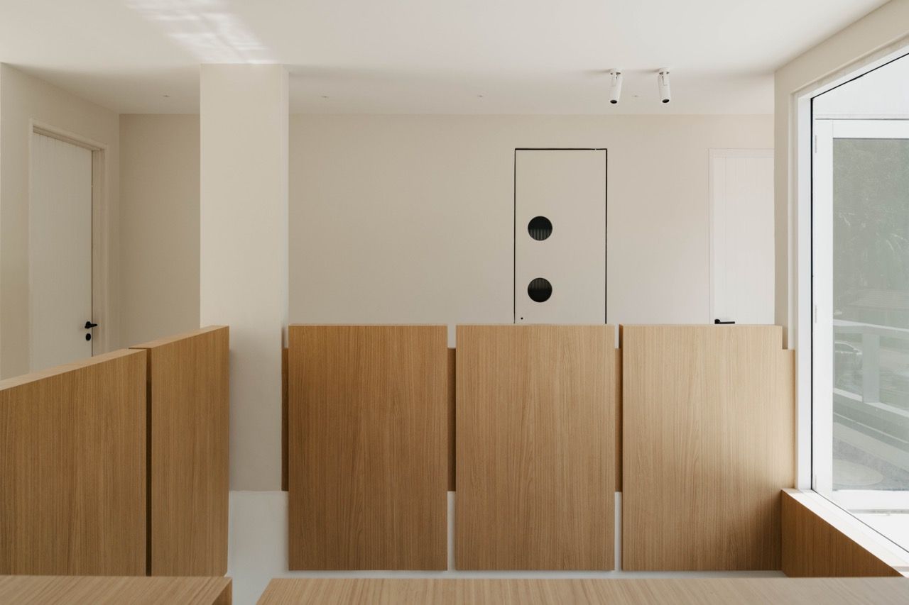The double-volume void area with natural wood staircase elements, created to draw light into the heart of the home