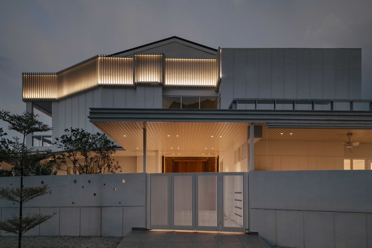 The white exterior shows the relocated side entrance and the corner terrace house structure
