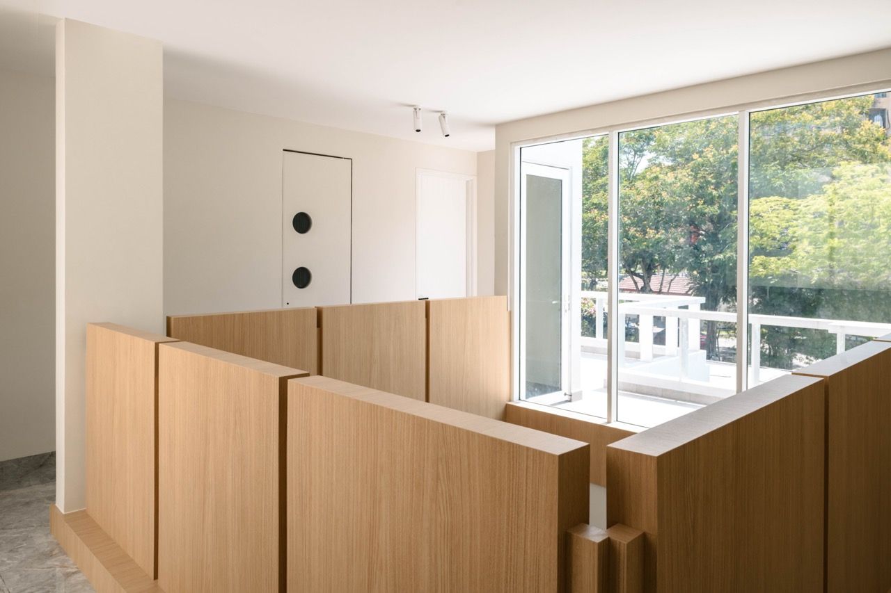 Upper level view of the void space showing the natural wood elements and the connection between floors