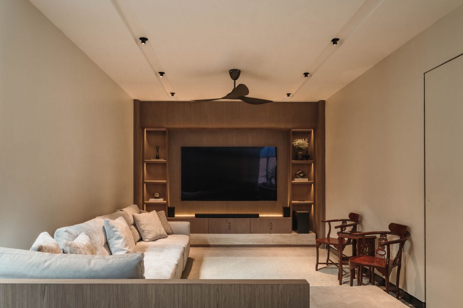 Living room featuring the King Living Richmond sofa and natural veneer media wall with built-in shelving, demonstrating the tone-on-tone palette that creates warmth throughout the home