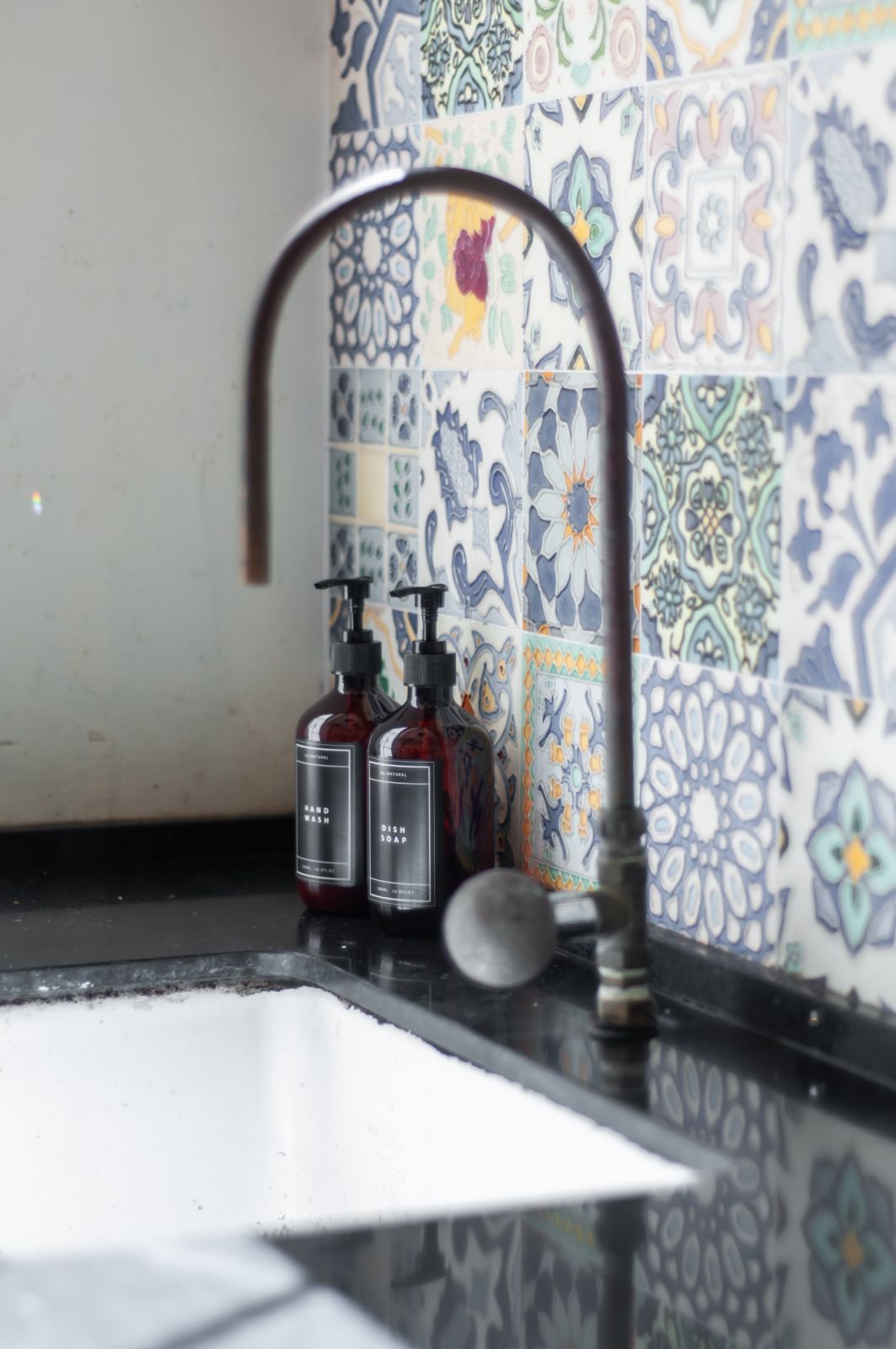 Ornate tiles repurposed as a backsplash (Photo: Aayu Homes)