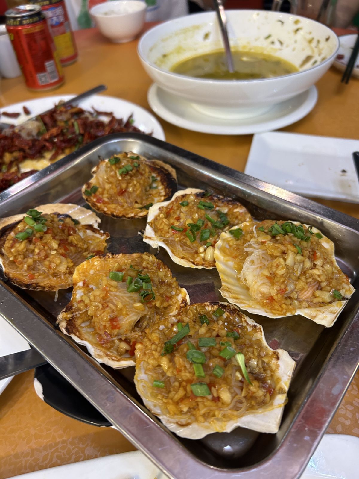 Scallops barbecued over fire, topped with garlic and chillies